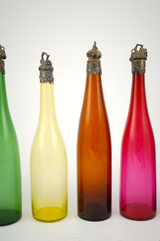 A composed set of six mid 19th century vari-coloured glass carafes